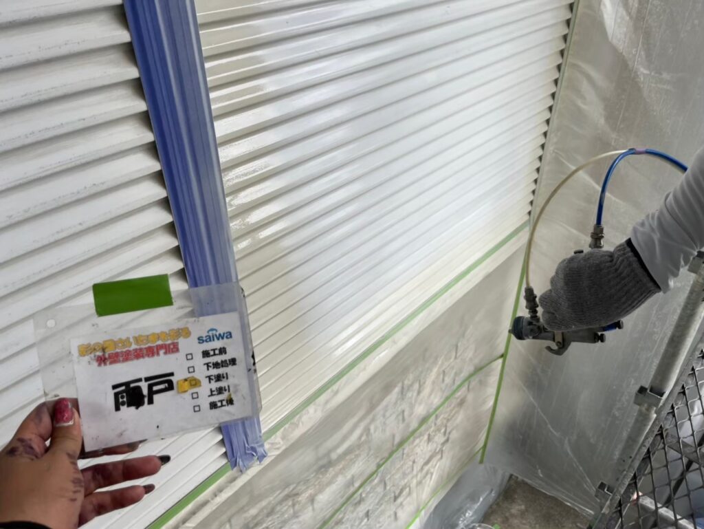 スプレーガンを使った雨戸の下塗り工程