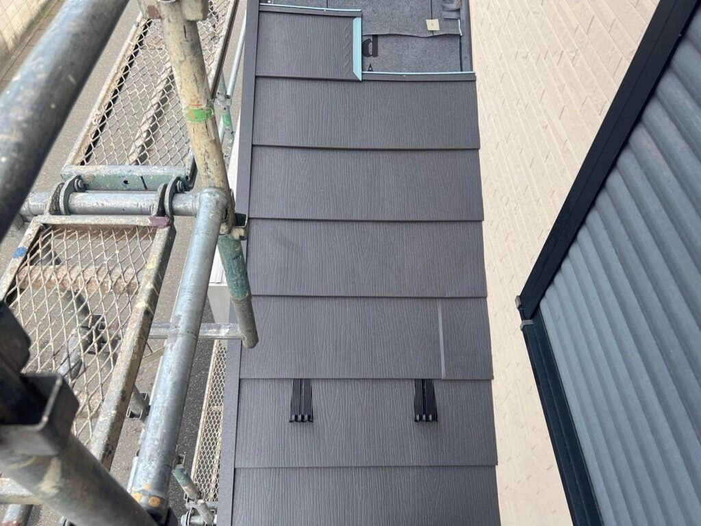下屋根カバー工法で新しい板金材を取り付けている様子。高品質な屋根材により耐久性が向上し、メンテナンス費用の削減にもつながる施工