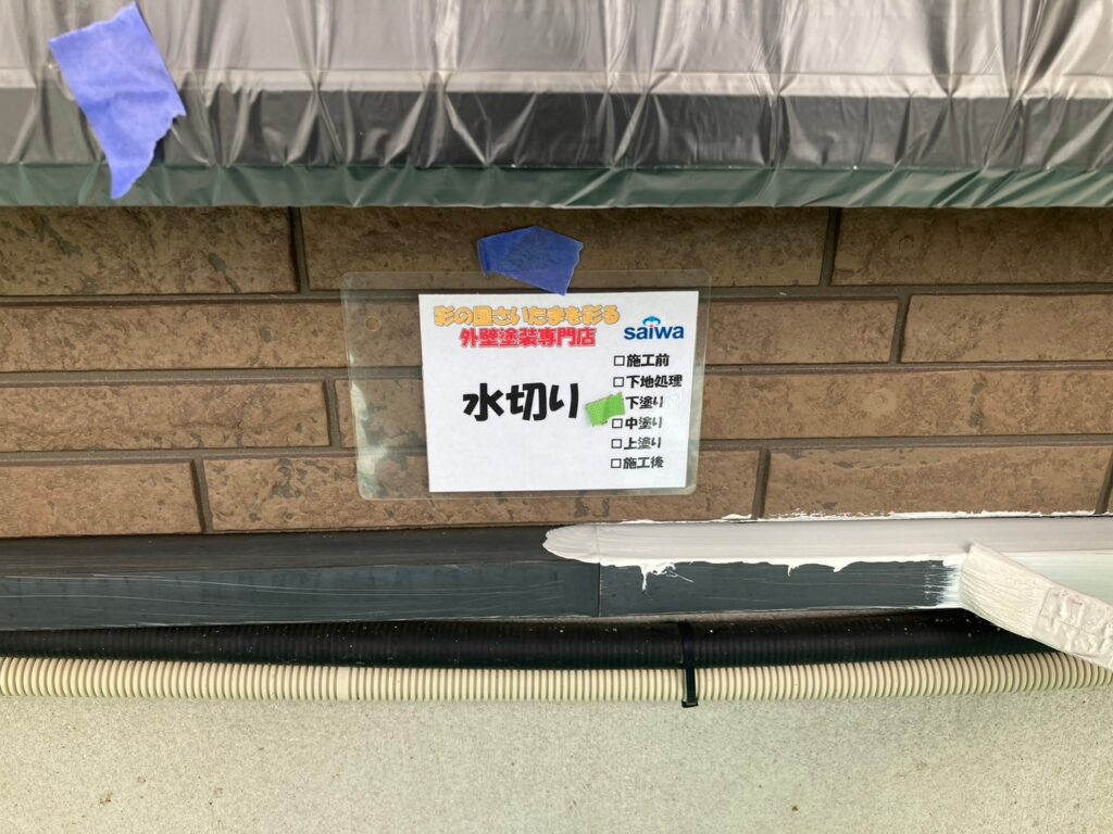 水切りへ下塗りを施工している写真。防錆効果を高め、長期耐久性を向上させるための重要な塗布工程