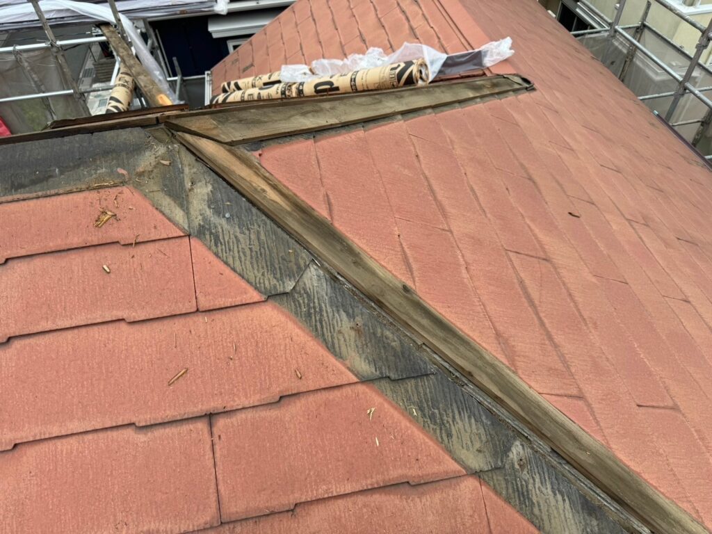 資格保有職人 屋根の棟板金を慎重に取り外している工程写真